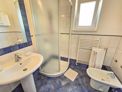 a bathroom with a sink and a shower and a toilet at MIMICA Double ROOM with private bathroom and terrace in Novi Vinodolski