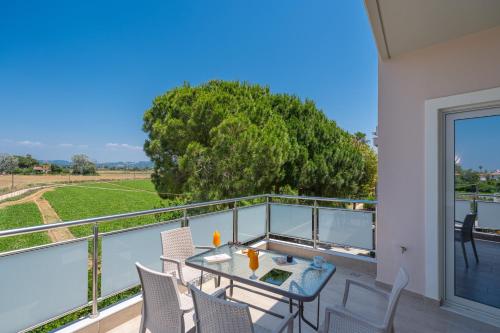 a patio with a table and chairs on a balcony at Harmony Hotel in Kourouta