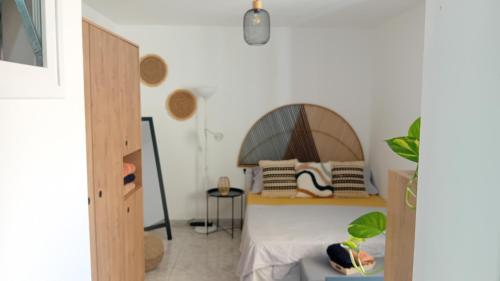 a bedroom with a bed with a wooden headboard at Hawaii house in Puerto del Rosario