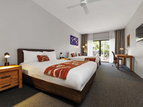 a hotel room with two beds and a window at Mercure Kakadu Crocodile in Jabiru