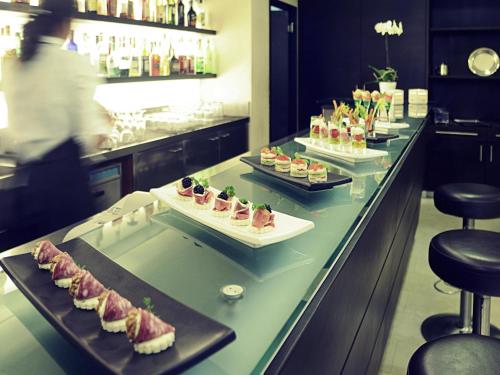 a buffet line with several plates of food on it at Mercure Genova San Biagio in Genova