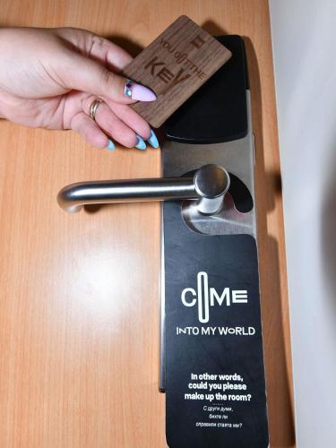 a woman is holding a spoon on a table at Ibis Sofia Airport Hotel in Sofia