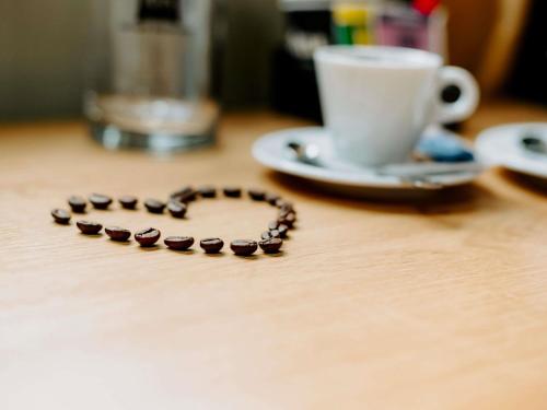 a wooden table with a heart made out of coffee beans at Ibis Sofia Airport Hotel in Sofia