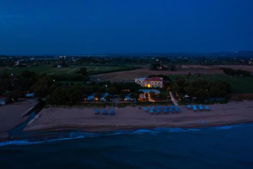 an aerial view of a resort on the beach at night at Harmony Hotel in Kourouta