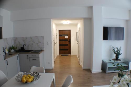 a kitchen and dining room with a table and chairs at VESTA Apartamenty M52 Free parking in Szczecin