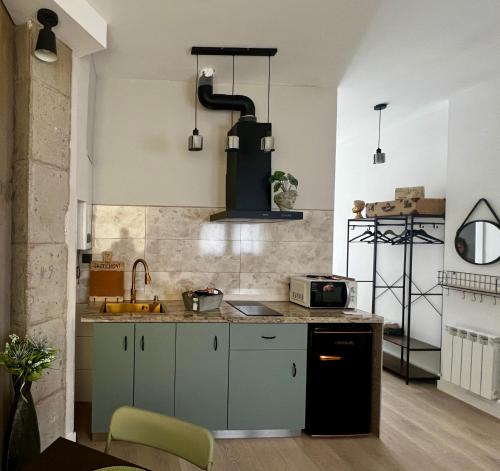 a kitchen with a sink and a stove at La Arquita, tu apartamento en Valladolid in Valladolid