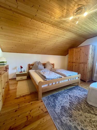 a bedroom with a bed and a wooden ceiling at Apartment Rossleithen 