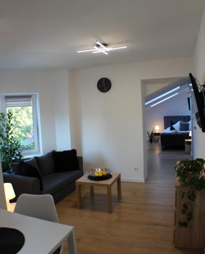 a living room with a couch and a table at VESTA Apartamenty M52 Free parking in Szczecin