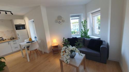 a living room with a couch and a table at VESTA Apartamenty M52 Free parking in Szczecin