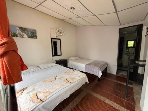 a room with two beds in a room at Finca Santa Helena in Restrepo