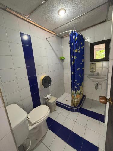 a bathroom with a toilet and a shower at Finca Santa Helena in Restrepo
