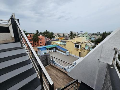 a balcony with a view of a city at Private Paradise Homestay in Puri