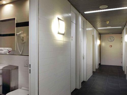 a hallway of a hospital room with a toilet at Mercure Hotel Schiphol Terminal in Schiphol