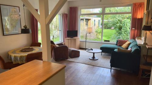 a living room with a couch and a table at De Boem in Westermient
