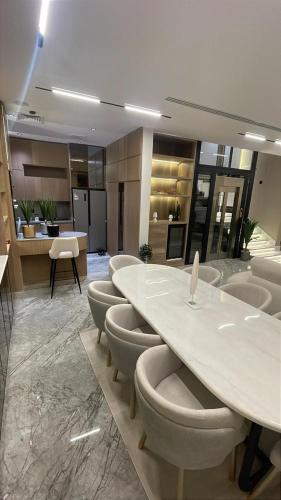 a conference room with a large table and chairs at Love Residence Al Arid in Riyadh