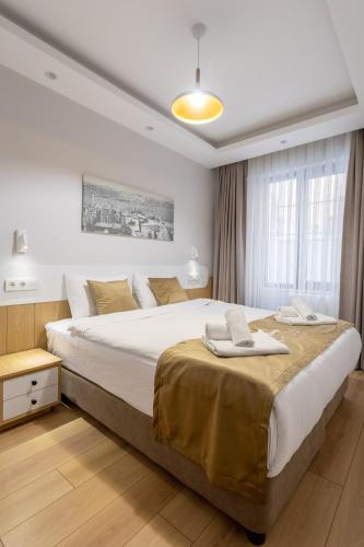 a bedroom with a large white bed with towels on it at Chido Residence in Istanbul