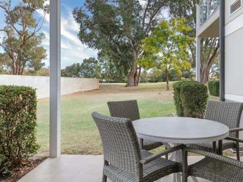 a patio with a table and chairs on a porch at The Sebel Swan Valley the Vines in The Vines