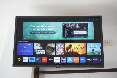 a computer monitor on a stand with movies on it at Akumal Hotel in Máncora