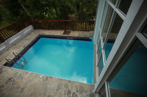 an overhead view of a swimming pool on a patio at Beach Grove Villas in Unawatuna