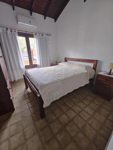 a bedroom with a bed and a large window at Casa en Villaguay in Villaguay