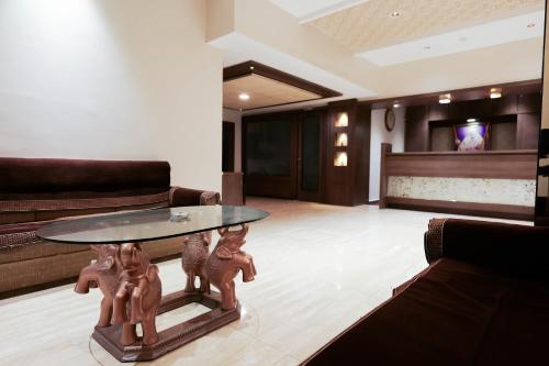 a living room with a table with animals on it at Hotel Laxmibai Palace- Only 300 miter from Sai Baba Temple!!!! in Shirdi