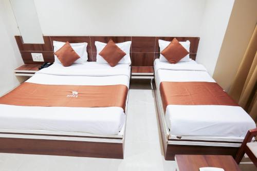 two beds in a hotel room with at Hotel Laxmibai Palace- Only 300 miter from Sai Baba Temple!!!! in Shirdi