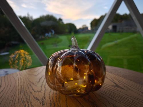 a glass pumpkin sitting on top of a table at Dôme Saint-Eloi in Floursies