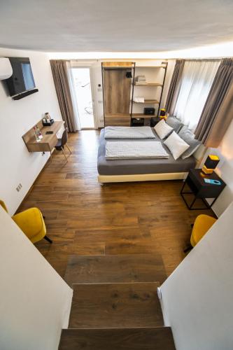 a large room with a bed and a table at Vinomare Guesthouse in Fosdinovo
