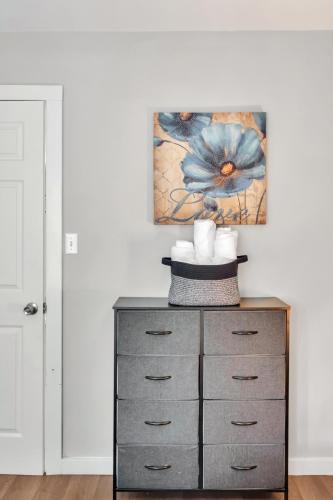 a dresser in a room with a painting on the wall at 4 Bed Moroccan style, min to UNC, Kids Essentials, Crib, walk to Golf in Chapel Hill