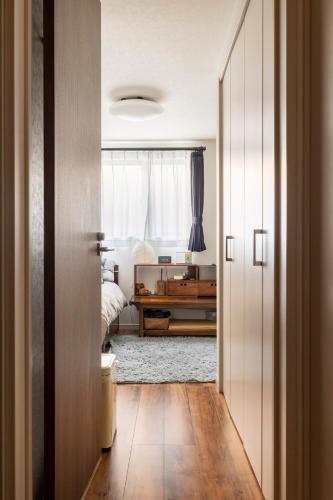 a hallway leading to a bedroom with a bed at Casa Descanso Private Room own Toilet & Shower in Tokyo