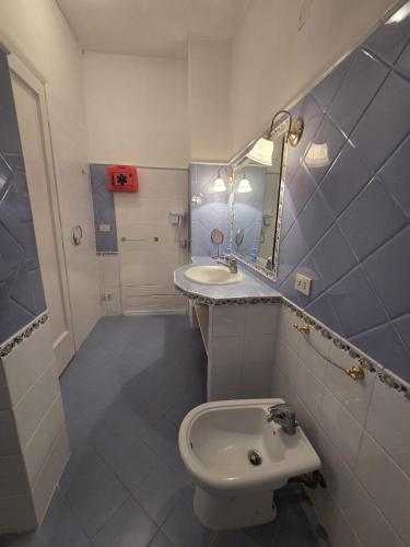 a bathroom with a sink and a toilet and a mirror at Alloggio Panorama in Rocca di Papa