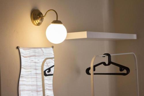 a light hanging from a wall next to a towel rack at Aurora Court Service Apartment in George Town
