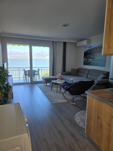 a living room with a couch and a table at Shiroka's Special Guest in Shkodër