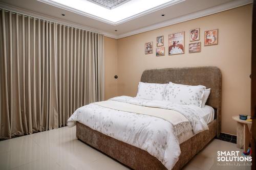 a bedroom with a large bed with white blankets and pillows at Twleen luxury 408 in Jeddah