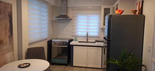 a small kitchen with a sink and a refrigerator at Flamboyant Residence 46 in Koolbaai
