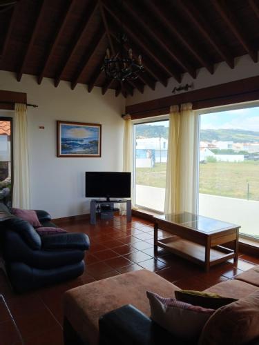 a living room with a couch and a table at Casa do Ilhéu in Vila Franca do Campo