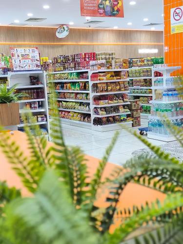 a grocery store aisle with shelves of food at Summer Suites KLCC by CozyNest in Kuala Lumpur
