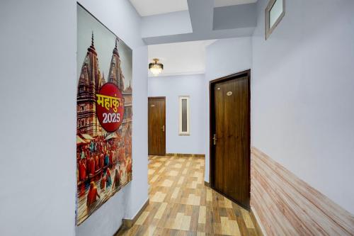 a hallway with a door and a poster on the wall at HOTEL O GOLDEN MAJESTIC in Prayagraj