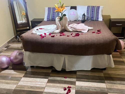 a bedroom with a bed with flowers and dolls on the floor at Estrella Ancestral 1 in San Pedro de Atacama