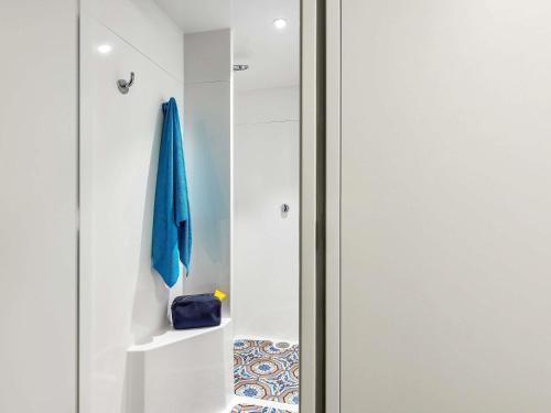 a bathroom with a glass door and a towel at hotelF1 Strasbourg Pont de l'Europe in Strasbourg