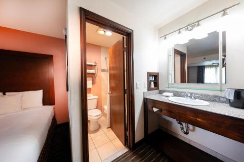 a hotel room with a bathroom with a bed and a sink at District Hotel by OYO Portland Convention Center in Portland