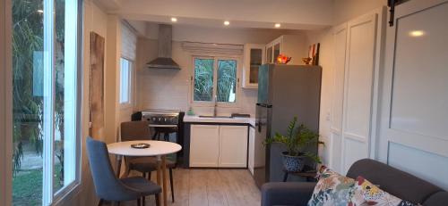 a small kitchen with a table and a refrigerator at Flamboyant Residence 46 in Koolbaai