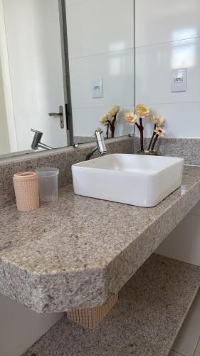 a white sink on a counter in a bathroom at Apto 2 Quartos Perfeito in Guarapari