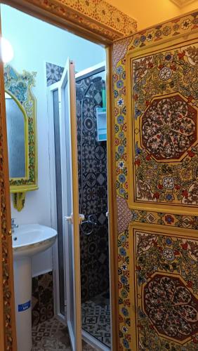 a bathroom with a shower and a sink at Riad Las mil y una noches 2 Tetuan in Tetouan