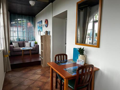 a dining room with a table and chairs and a couch at Apartments Vista Oceano in Funchal