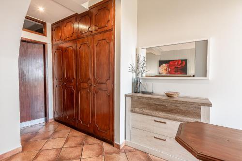 a room with a wooden closet and a wooden table at Apartments Vista Oceano in Funchal