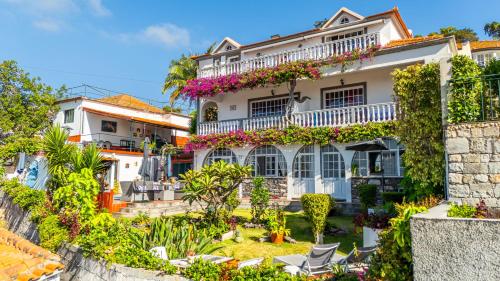 a house with a garden in front of it at Apartments Vista Oceano in Funchal