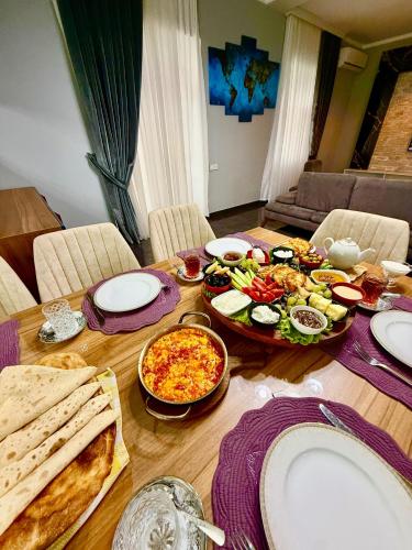 a wooden table with food on top of it at Qafqaz Fountain Villa in Gabala