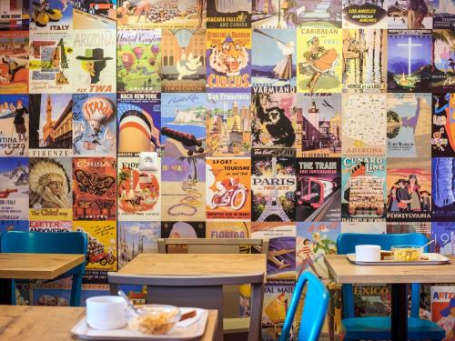 a mural offamous posters on the wall of a restaurant at hotelF1 Avignon Nord in Sorgues