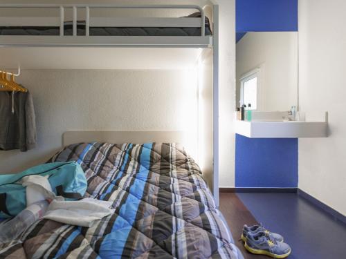 a bedroom with a bed and a sink in it at hotelF1 Merlebach Saarbrueck in Merlebach
